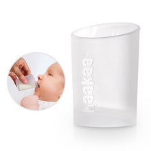 Load image into Gallery viewer, Clear container, a feeding cup with Haakaa imprinted and a small inset showing a baby using the product.
